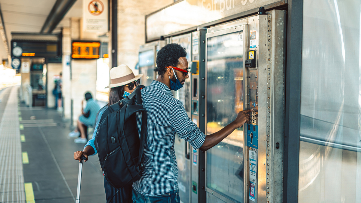 People using vending machines at a transit station