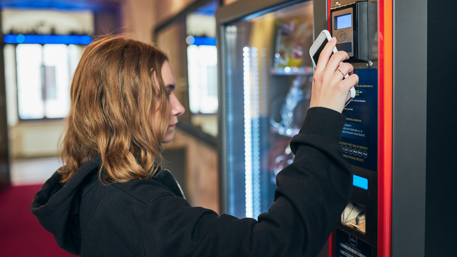 erson using contactless payment at a vending machine