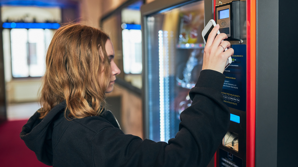 erson using contactless payment at a vending machine